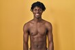 © Krakenimages.com - Young african man with dreadlocks standing shirtless with a happy and cool smile on face. lucky person.