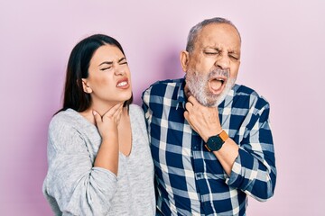 Sticker - Hispanic father and daughter wearing casual clothes touching painful neck, sore throat for flu, clod and infection