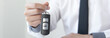 © Puwasit Inyavileart - Car dealers or insurance managers cover and protect against damage and the risk of driving, Hold the car keys, Protecting and after-sales care concept.