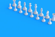 Set Of White Chess Figures On Blue Background. Table Games. International Tournament. Hobby And Leisure. Copy Space. 3d Render