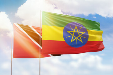 Sunny blue sky and flags of ethiopia and trinidad and tobago