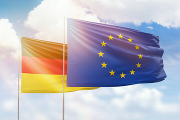 Sunny blue sky and flags of european union and germany