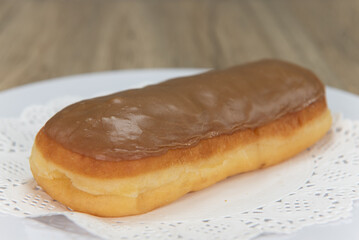 tempting fresh from the oven maple bar donut from the bakery served on a plate