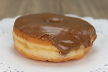 tempting fresh from the oven maple donut from the bakery served on a plate