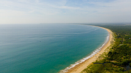 Beautiful beach, palm trees by turquoise water view from above. Kalkudah Beach, Sri Lanka.