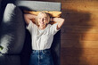 © baranq - Laughing adult woman lying on the sofa at home relaxing with eyes closed
