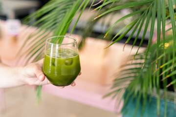 Woman holding Matcha iced green tea. Detox iced drink still life