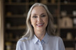 © fizkes - Head shot of middle-aged attractive businesswoman standing in office posing for cam, having wide candid toothy smile staring at camera feels happy. Portrait of baby boomer generation female concept
