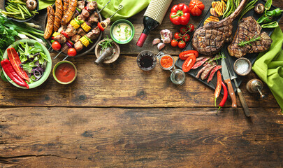 Grilled meats and vegetables on rustic picnic table