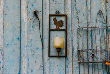 Wrought Iron Decorations Hung On A Natural Wood Panel With The Trace Of Fibers And Chips Of Blue Flaked Paint Symbol Of Provence