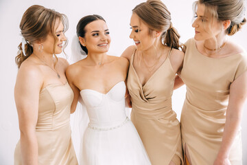 beautiful laughing bride with bridesmaids in the morning before the wedding