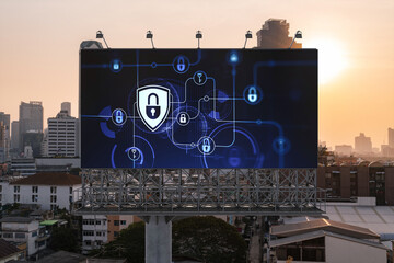 Padlock icon hologram on road billboard over panorama city view of Bangkok at sunset to protect business, Southeast Asia. The concept of information security shields.