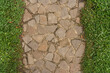 Straight line of stone pavement and lawn on both sides. Top view