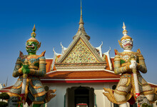 The Two Of Giant Statue At Wat Arun "Temp;e Of Dawn" Landmark In Bangkok, Thailand.
