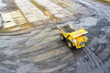 Wall Mural - Top view of a yellow mining dump truck during mining operations