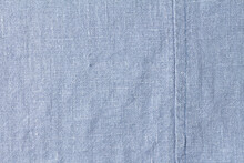 Texture Of Blue Denim With A Seam And A Small Defect