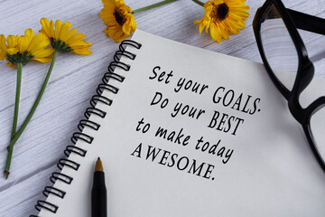 Wall Mural - Motivational quote on note book with sunflowers on wooden desk.