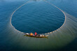 Local fishermen are fishing in river with huge net. Aerial View taken with drone.