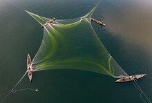 Local Fishermen Are Fishing In River With Huge Net. Aerial View Taken With Drone.