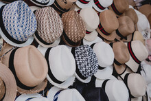 A Variety Of Fashionable And Colorful Hats Are In Outdoor Store Stacked In A Row