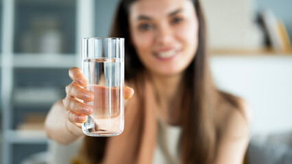 Young woman drinks a glass of water