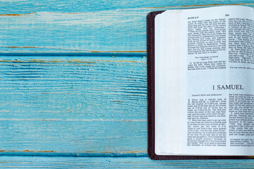 Wall Mural - 1 Samuel open Holy Bible Book on a rustic wooden background with copy space. Top table view. Old Testament Scripture study, Christian biblical concept.