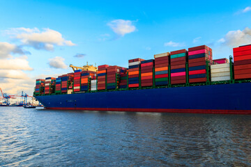 Huge cargo container ship sailing on the Elbe river, Hamburg, Germany