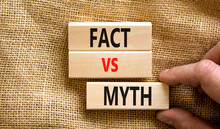 Fact Vs Myth Symbol. Concept Words Fact Vs Myth On Wooden Blocks On A Beautiful Canvas Table Canvas Background. Businessman Hand. Business, Finacial And Fact Vs Myth Concept. Copy Space.