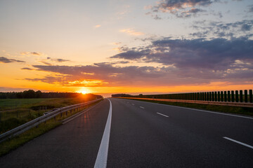 Wall Mural - empty highway during a spectacular sunset