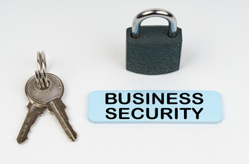 Poster - On a white surface there is a lock, keys and a blue sign with the inscription - Business security
