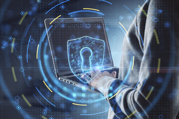 Poster - Close up of hacker hands using laptop keyboard with glowing security padlock on blurry office interior background. Secure, hacking, safety and digital protection concept. Double exposure.