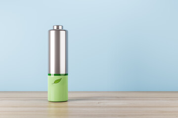 Poster - Green energy and eco technology concept with silver battery and green leaf on wooden surface and blank light blue wall with place for your logo or text background. 3D rendering, mock up