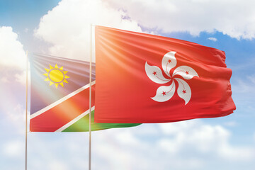 Sunny blue sky and flags of hong kong and namibia