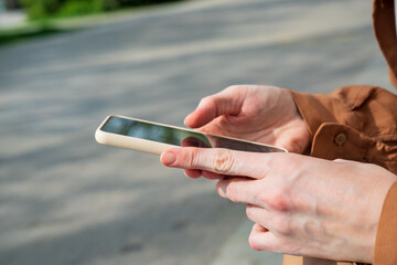 Women's hands with smartphone. View news and social networks on your phone.