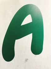 Dark Green Letter A On Cement Wall Can Be Used As A Symbol