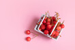 a handful of sweet cherries in a cart, sweet cherry on pink background