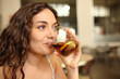 © Antonioguillem - Happy woman drinking soda from glass in a coffee shop