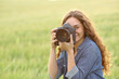 © Antonioguillem - Woman taking photos in a wheat field
