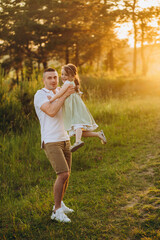 Wall Mural - Happy father playing and carrying his daughter on shoulders.