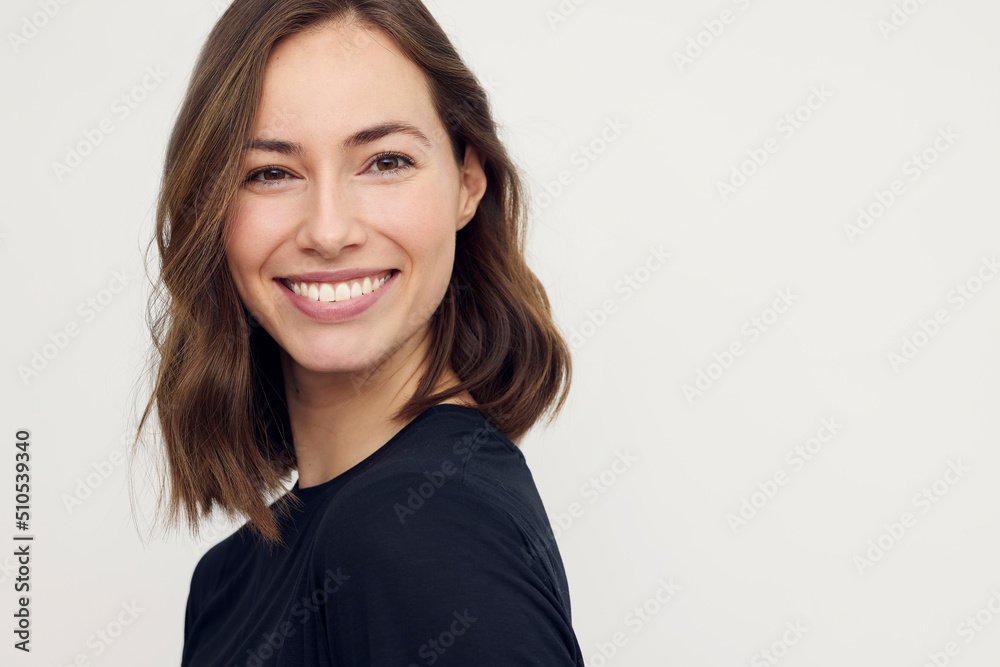 Young brunette woman smiling with a beautiful smile in camera, isolated ...