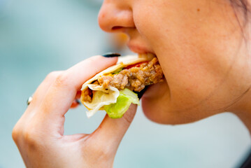 Wall Mural - woman eat taco outdoor traditional in mexican food. street food