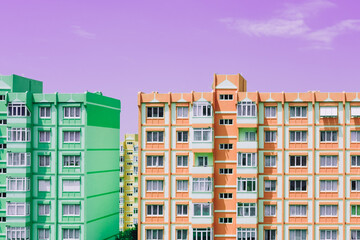 green and orange panel building architecture houses on purple sky background. nine-story old urban r