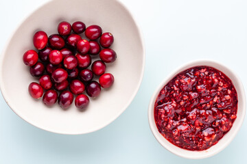 Wall Mural - Cranberries in white bowl on pastel background.