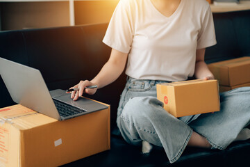 Wall Mural - Asian woman working in modern warehouse and delivery service via modern technology