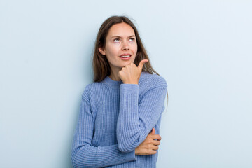 Wall Mural - young adult pretty woman thinking, feeling doubtful and confused, with different options, wondering which decision to make