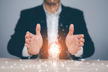 Poster - Creativity in the hands of business people idea concept, Businessman holding glowing light bulb with drawing brain and connection line, creative thinking ideas and innovation technology and creativity