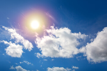 Wall Mural - Sunny background with blue sky and sun as summer natural background.