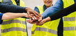 hands together of multiracial people, teamwork engineers in factory, workers hands together in warehouse