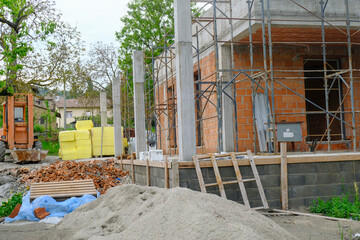 construction site with equipment and building. House in construction close-up. Building construction site. Construction works