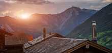 Alpine Wooden Houses In Switzerland, Europe. Mountain Scenery In The Alps With Fresh Green Meadows On A Beautiful Sunrise In Springtime. Vintage Tone Filter Effect With Noise And Grain.